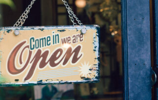 Open sign hanging on a retail store window