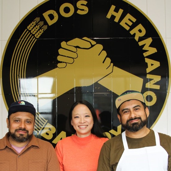 Dos Hermanos owners Josue Azcorra (left) and Gabriel Azcorra (right), pictured with Prosper Portland Food & Beverage Manufacturing / Tech & Media Industry Liaison Yvonne Smoker (center).