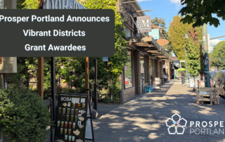Prosper Portland announces Vibrant Districts Grant Awardees. An image in the background shows a street (NE Broadway) with trees and small businesses.