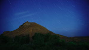 A photo of a mountain against the night sky.
