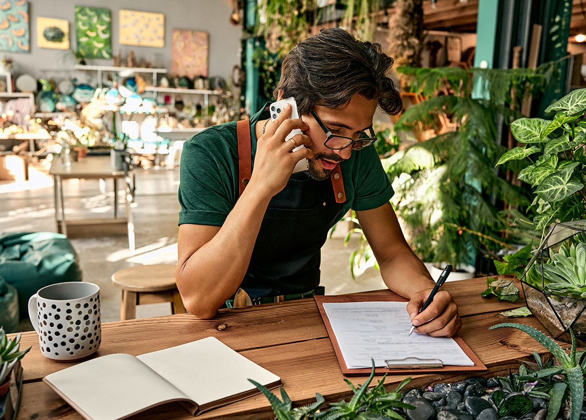 florist on the phone taking orders business owner taking a call